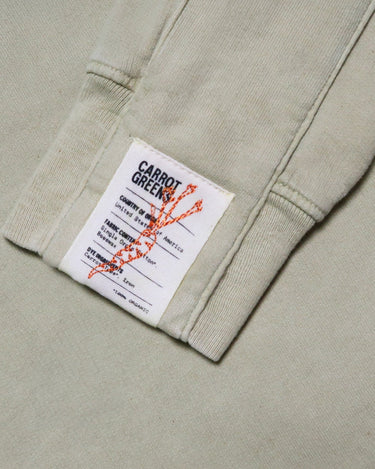 Close-up of organic cotton fabric showing the texture and natural dye variations from carrot extract.